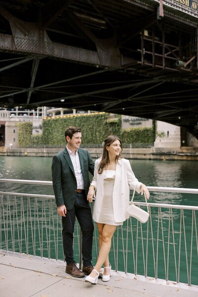 engagement photo shoot of couple by the water in minnesota both looking to the side photographed by tom thornton photography