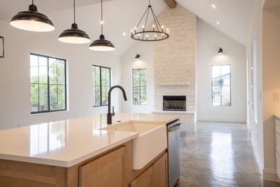white kitchen island open to vaulted ceiling living room