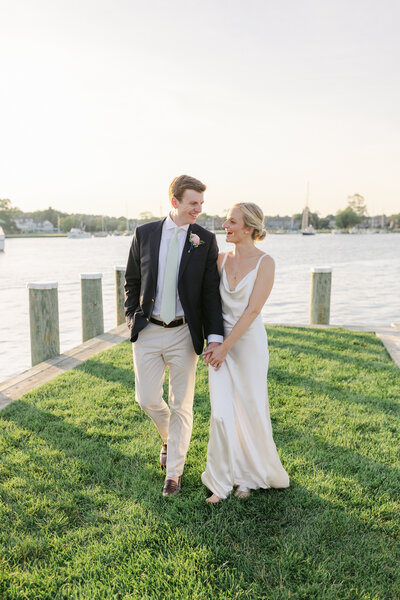 black and white portrait of bride and groom kissing in a field