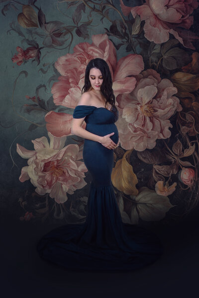 Maternity mama with her hands lovingly on her belly looking down at her own profile