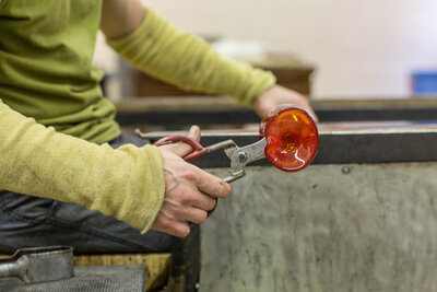 scissors cutting hand blown glass