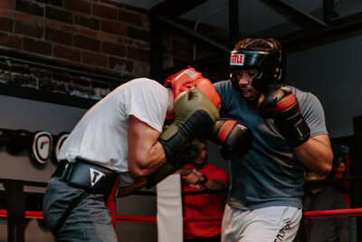 Two people boxing in a ring