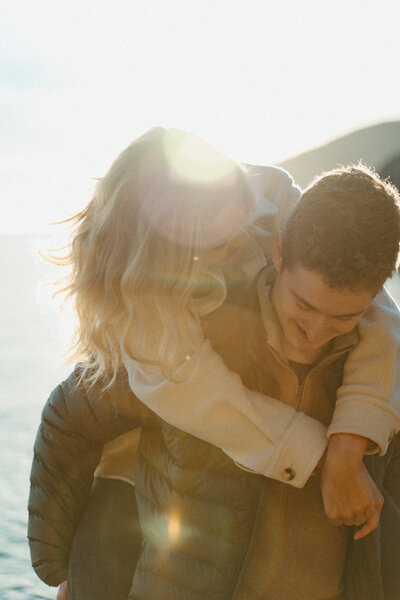 dreamy golden hour engagement photo of an eskimo kiss