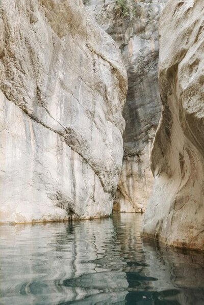 Rock formation with clear blue water – grounding nature visual for emotional regulation and self-trust