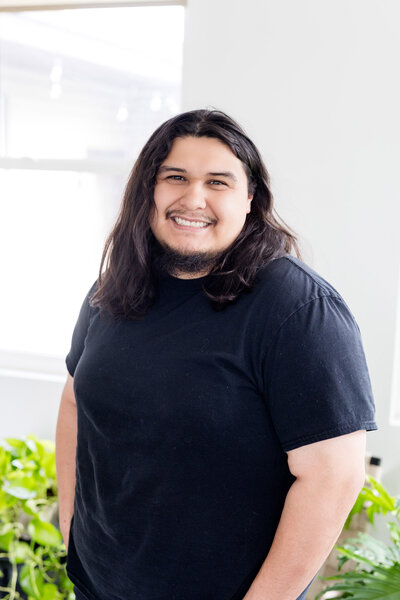 Theo smiling in front of a window