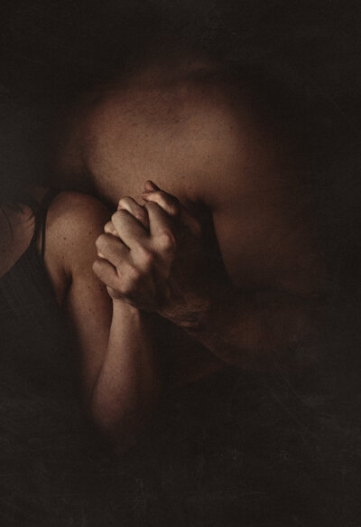 Artistic self-portrait of Shannon Kathleen and husband holding hands in intimate light, symbolizing personal growth and connection through online dating