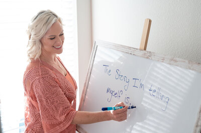 woman writing notes on whiteboard