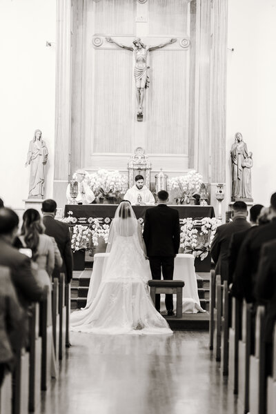 Bride & Groom stand at the alter in saint Anne's Catholic Parish during Consecration