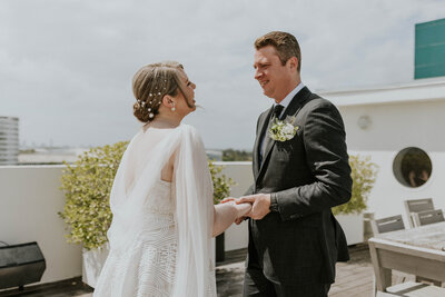 J&B holding hands at altar.