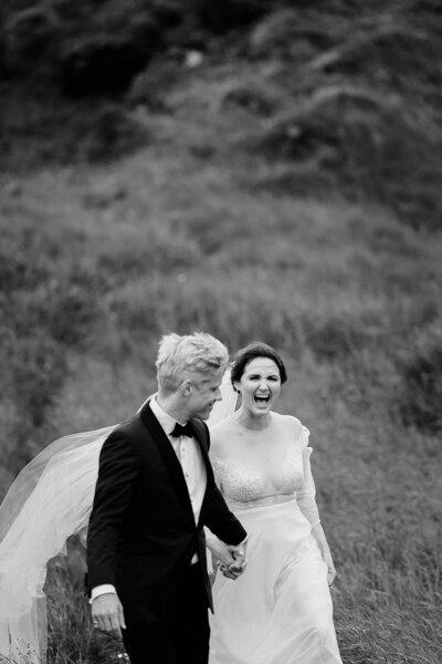 Black and white couples portrait of a bride and groom in a field