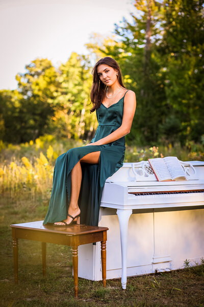 Graduating senior sitting on top of piano | Senior Portraits