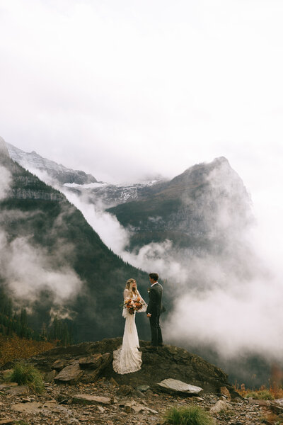 couple exchanging vows in front of aframe