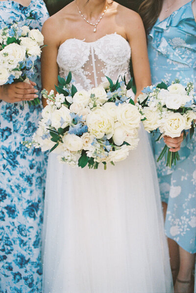 bridesmaids holding bouquets in floral dresses