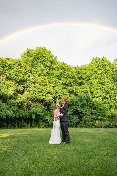 Fun Richmond Virginia bride and groom pose under a rainbow