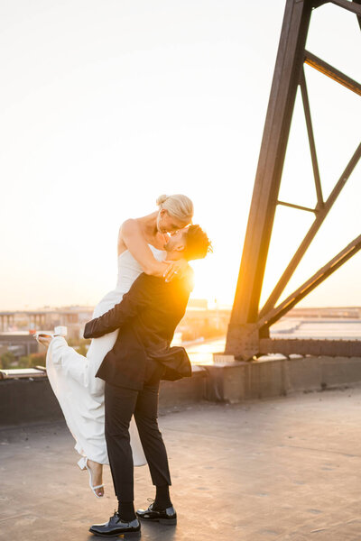Milwaukee wedding photos of couple on rooftop during sunset
