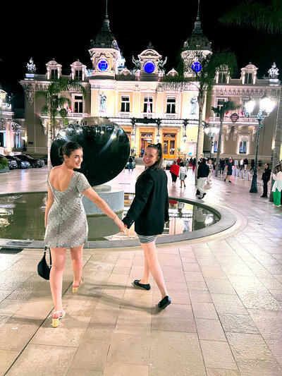 Madison holds hands with a friend as they stroll toward the iconic Monte Carlo Casino in Monaco.