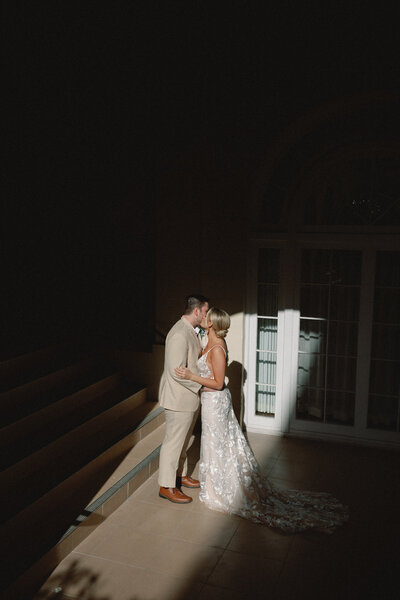 married couple walking along the palm tree covered sidewalk at casa marina key west