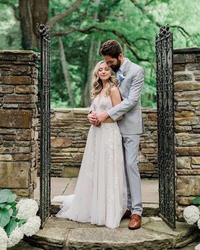 groom hugging bride from behind