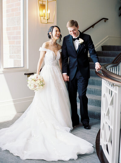 Seattle Wedding Photographers -bride and groom laughing hysterically on stairs while holding bouquet