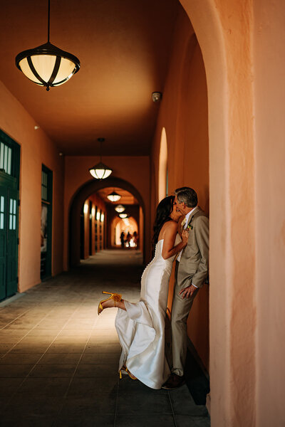 Bride preparing for her San Antonio wedding, adjusting her dress and holding her bouquet, captured by CMH Studios in editorial style.