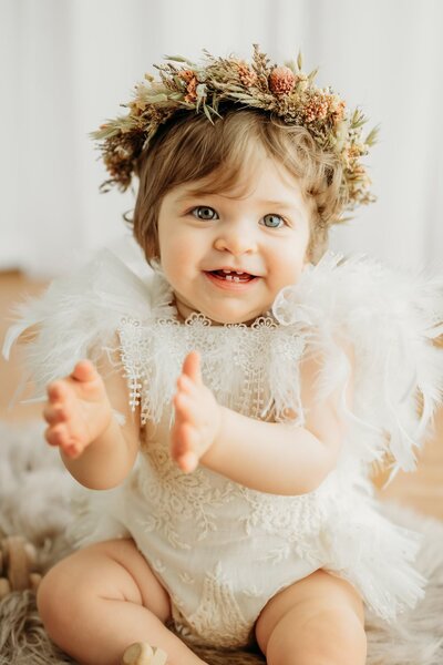 studio portrait of toddler on white backdrop