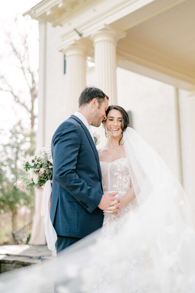 Groom kissing bride on cheek during Charlottesville wedding photos