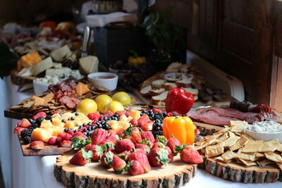 Variety of platters of fruits, crackers, meats and dips