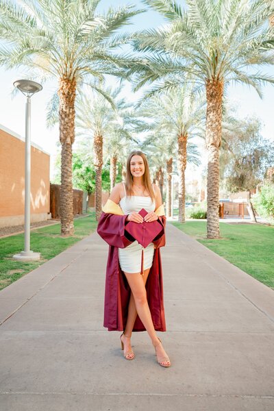 Arizona State University graduate posing for senior photos at palm walk in tempe az