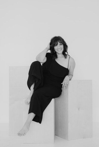 woman posing on blocks for headshot