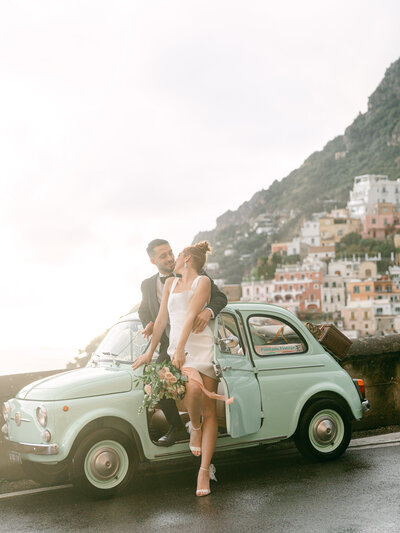 A girl wearing fA beautiful girl wearing a beautiful flowy Patbo sea foam teal green dress and a guy running holding hand with palm trees at beach