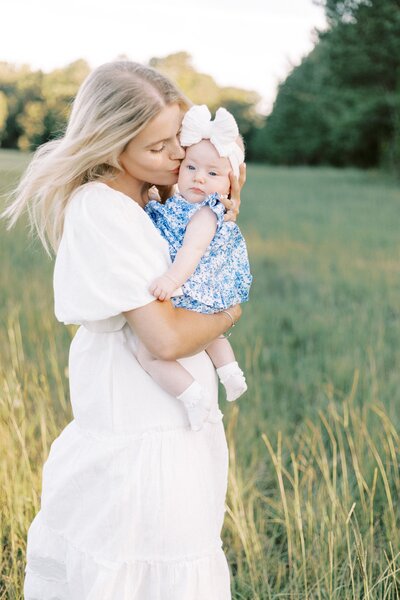 mom kissing baby in outdoor peoria, illinois family photos 