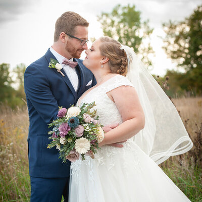 bride and groom touching noses together