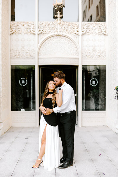 Explore Baylee and Trace’s romantic downtown OKC engagement session, featuring marble architecture, golden hour light, and timeless black-and-white style. Captured by Bree Smith Photography.