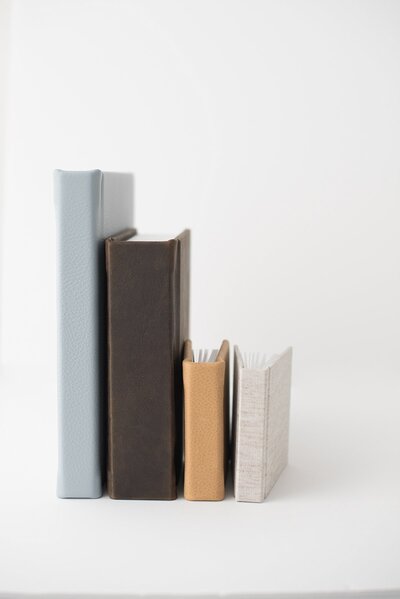 Four albums beside each other on a white background.