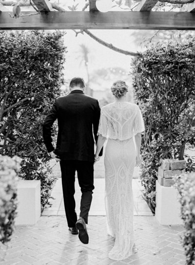 bride and groom walking away at la jolla wedding - Jacqueline Benét