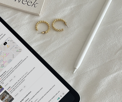 tea and croissant sitting next to a computer in a cafe