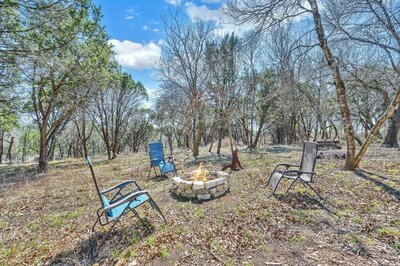Fire pit of this three-bedroom, two-bathroom vacation rental lake house that sleeps eight just steps away from Stillhouse Hollow Lake in Belton, TX.