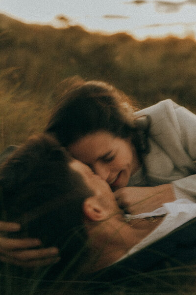 Intimate couples photo on the Sunshine Coast in motion showing close-up of boyfriend and girlfriend laughing in a close embrace
