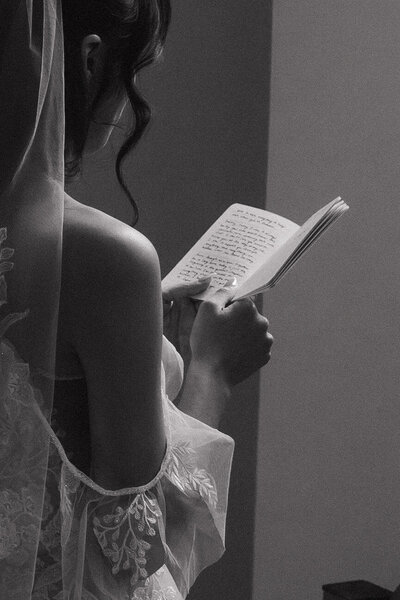 bride reciting vows back to back with husband captured by Tarah Shea, cinematic wedding photography