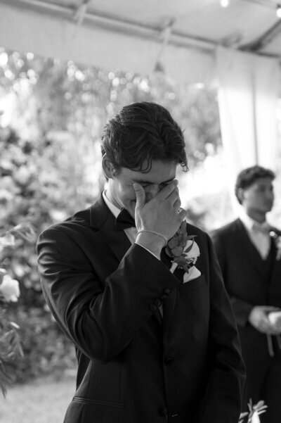 Groom crying and wiping eyes taken by Shelby Ann Photos, a jacksonville wedding photographer