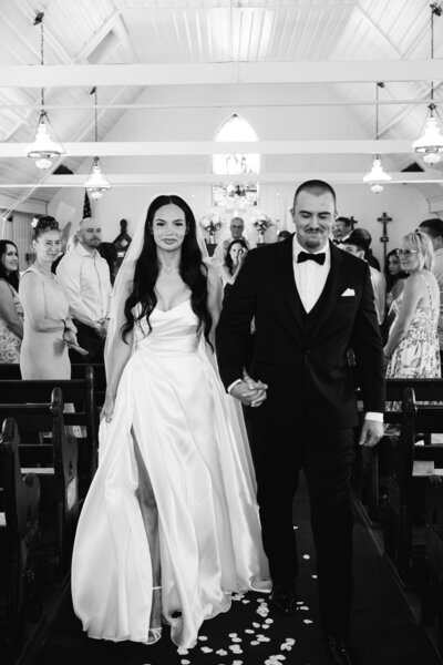 white chapel wedding tacoma in black and white bride and groom aisle