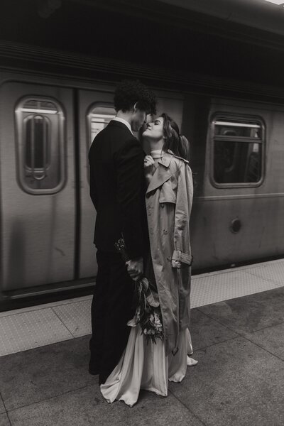 Elopement session couple kisses in front of the new york city subway