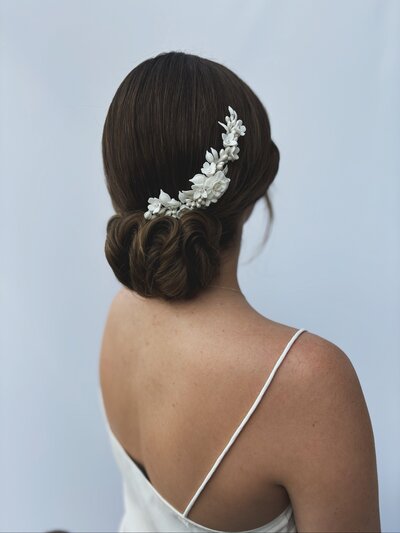 Couture style elegant low bun for high end bride with floral comb, Hengrave Hall Wedding