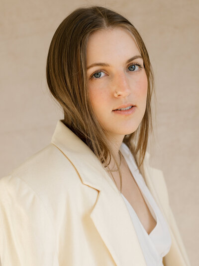 Close up portrait of Bailee in a white jacket looking at the camera