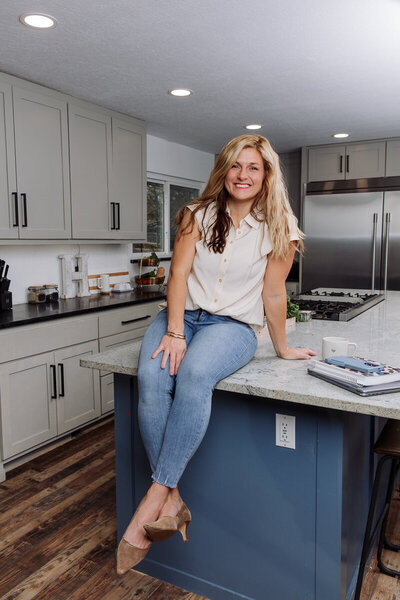 Amy, a functional nutritionist, smiling while preparing a healthy meal in the kitchen.