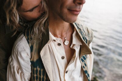 Same sex couple close up of embrace and romantic styling 
