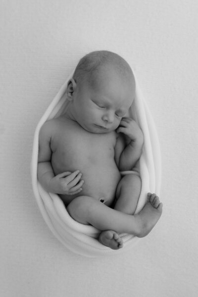 baby sleeping on fabric