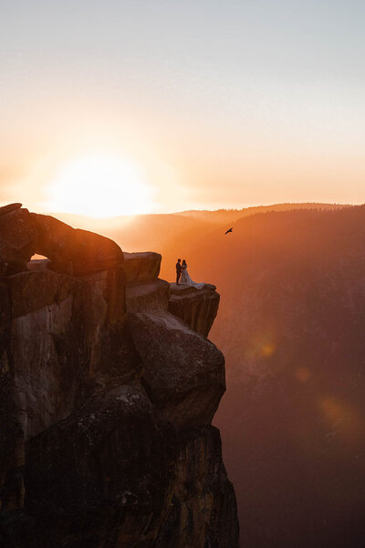 A couple starting their Yosemite Elopement during sunrise at Glacier Point