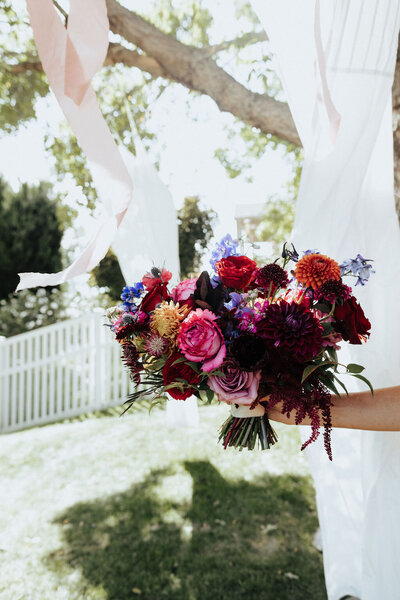 romantic moody wedding bouquet with garden roses dahlias ranunculus amaranthus