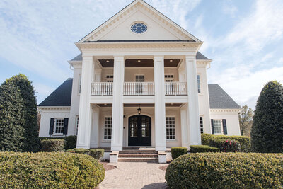Stunning wedding venue with a grand entrance and classic white columns for an elegant event.